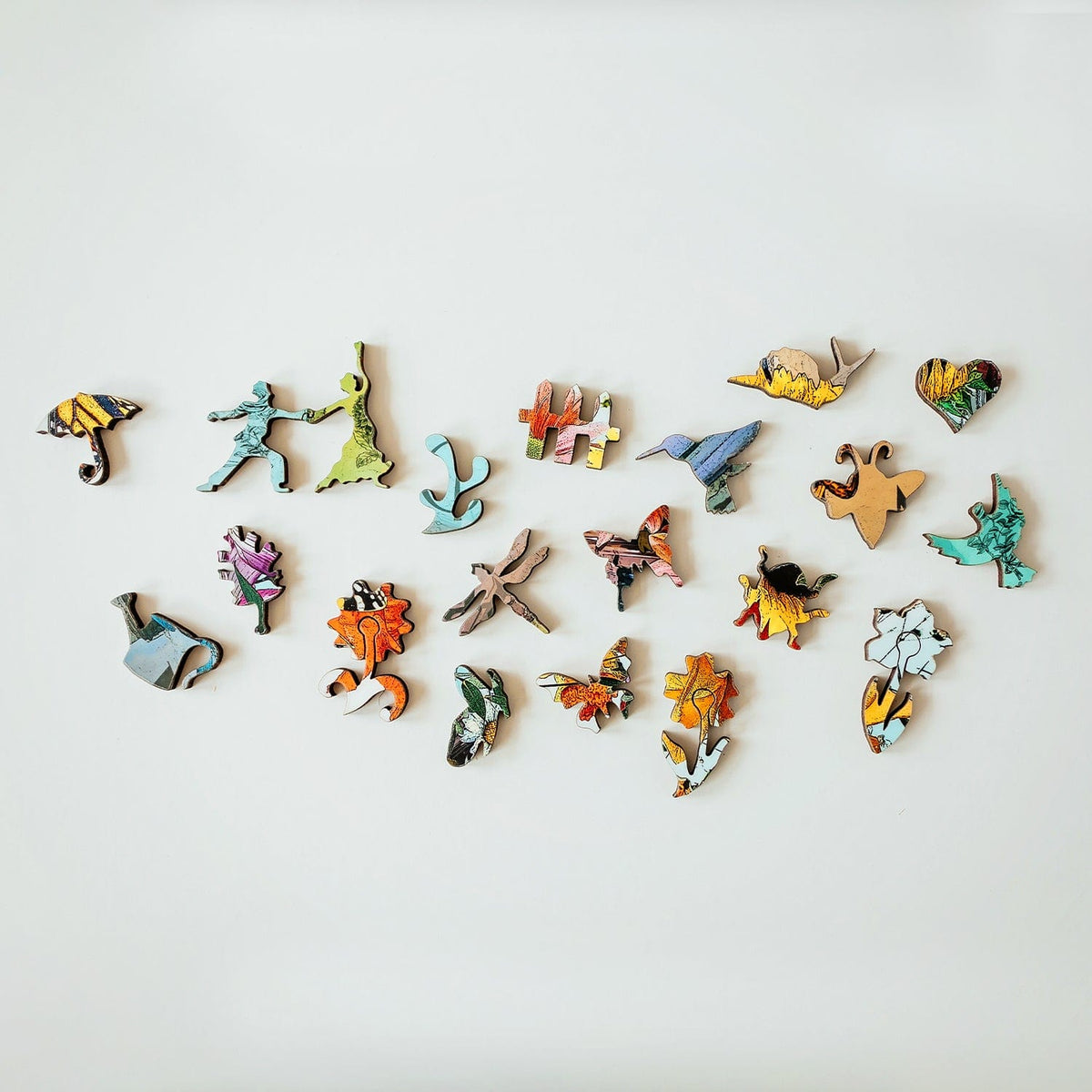 20 whimsical puzzle pieces from butterflies to birds
