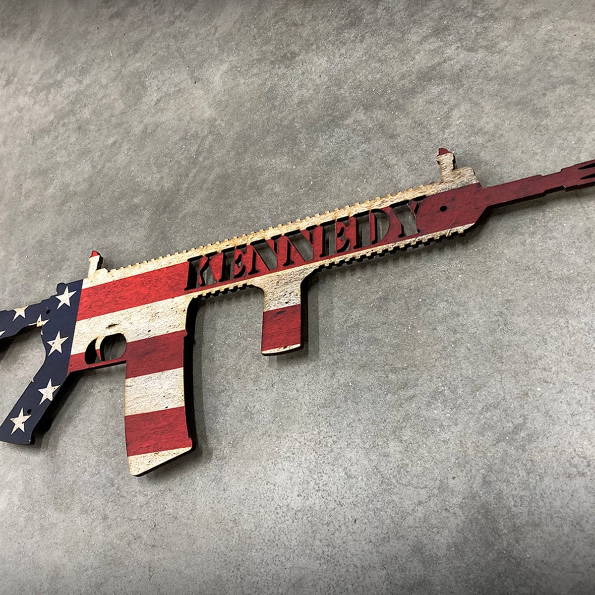 Customized wood AR gun sign with American flag background and your name in the wood sign