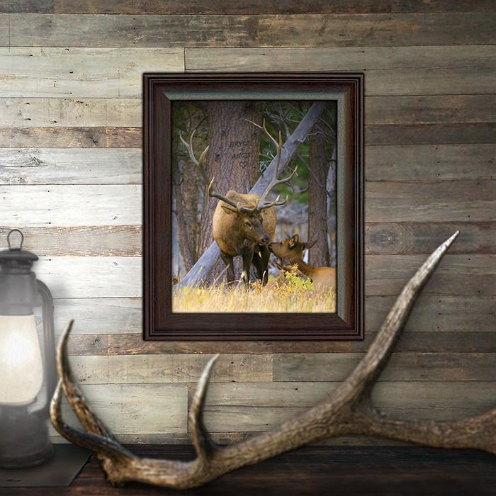 Rustic cabin decor elk print featuring two elk in the woods, one laying down reaching up to kiss the other - Lifestyle 